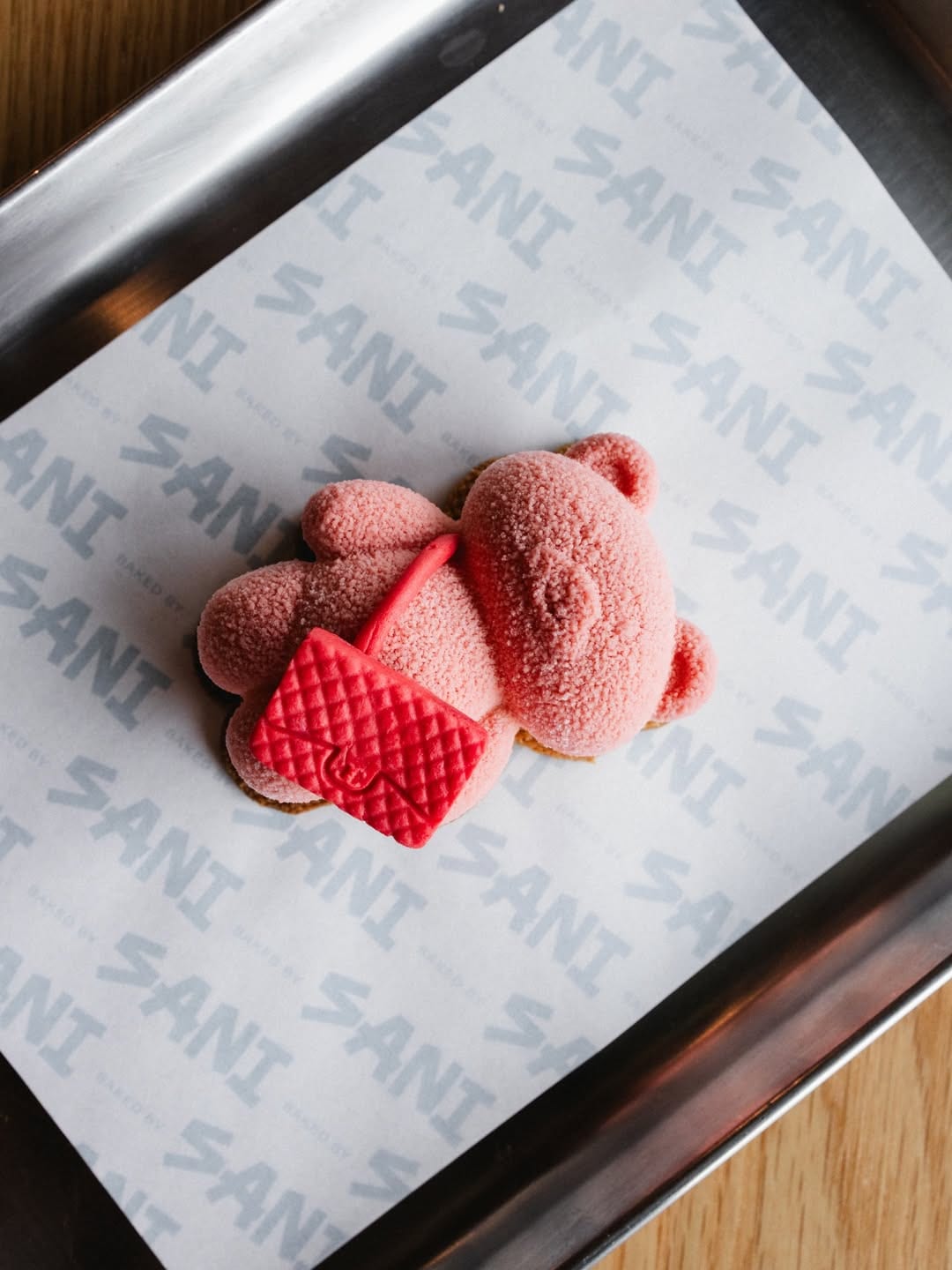 Pink Sani Bear pastries on SANI branded paper