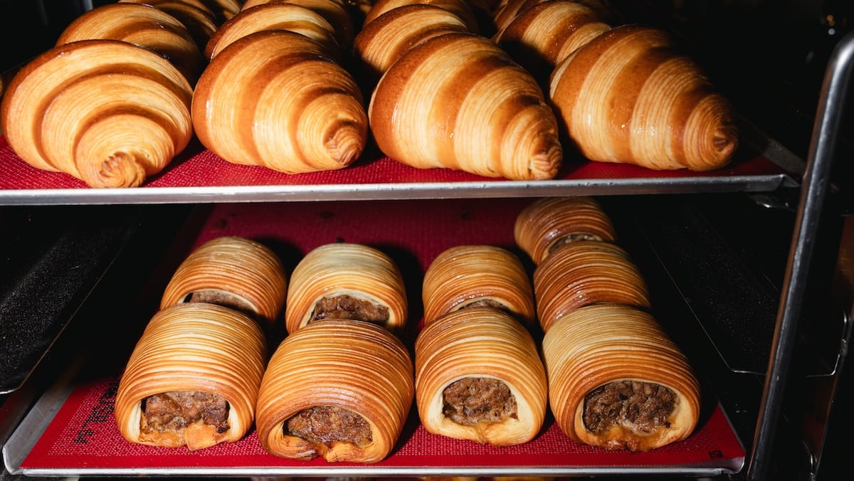 Trays of croissants and sausage rolls in the SANI Bakehouse cabinet